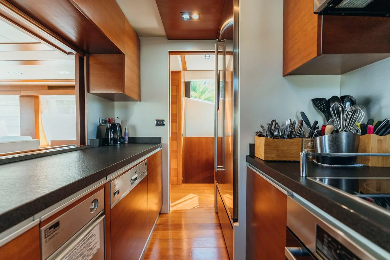 a kitchen with wooden cabinets aboard RESET Yacht for Sale