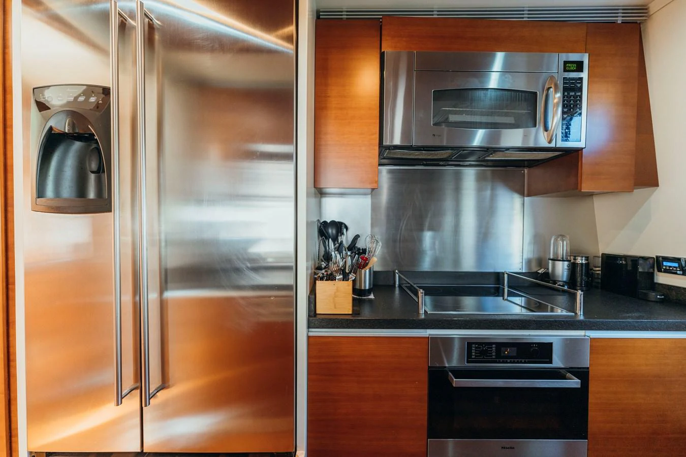 a stainless steel refrigerator in a kitchen aboard RESET Yacht for Sale
