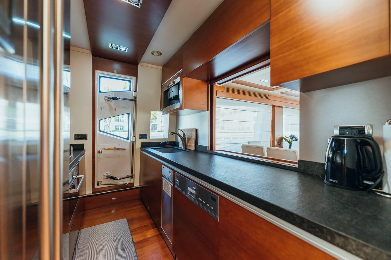 a kitchen with a black counter aboard RESET Yacht for Sale