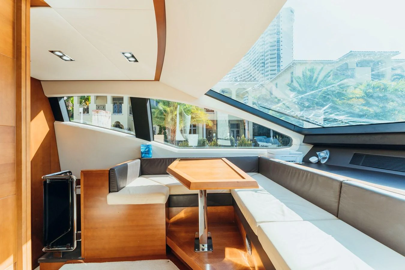 a room with a tv and a table and a window aboard RESET Yacht for Sale