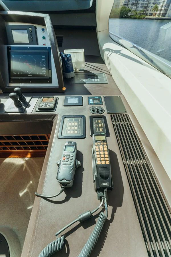 a desk with a computer and a television on it aboard RESET Yacht for Sale