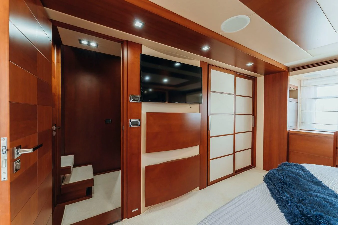 a room with a bed and a closet aboard RESET Yacht for Sale