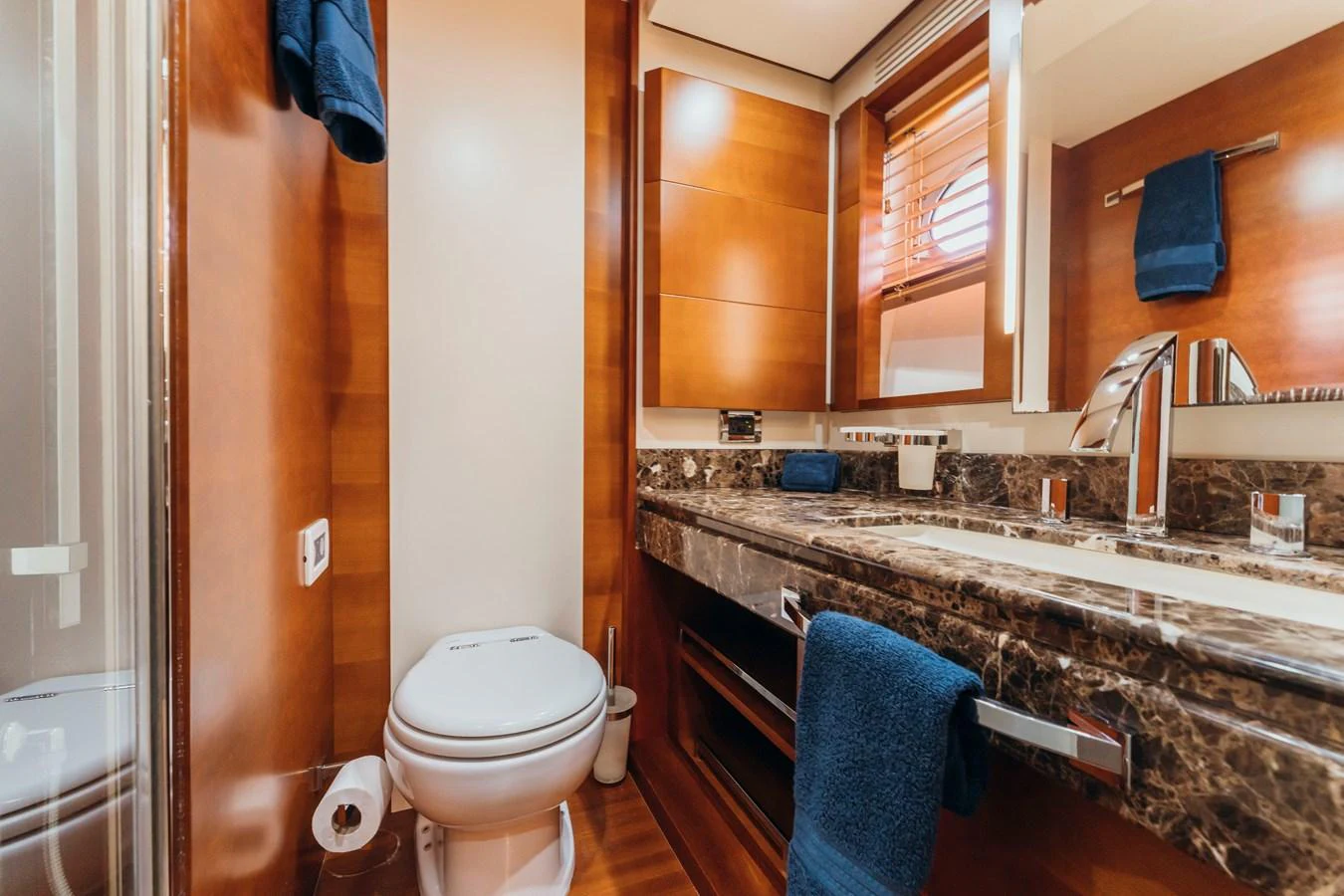 a bathroom with a sink toilet and a mirror aboard RESET Yacht for Sale
