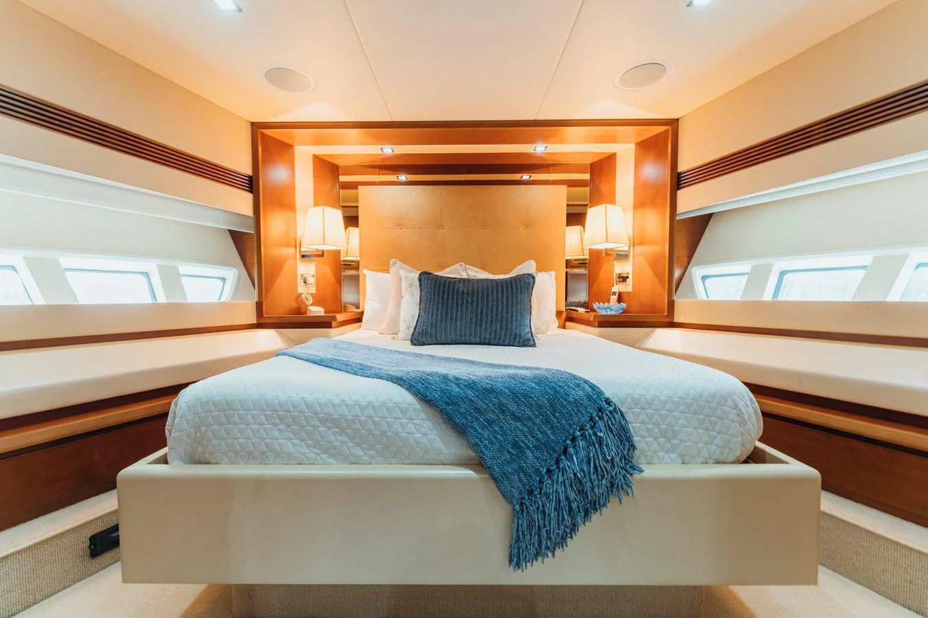 a bed with blue sheets aboard RESET Yacht for Sale