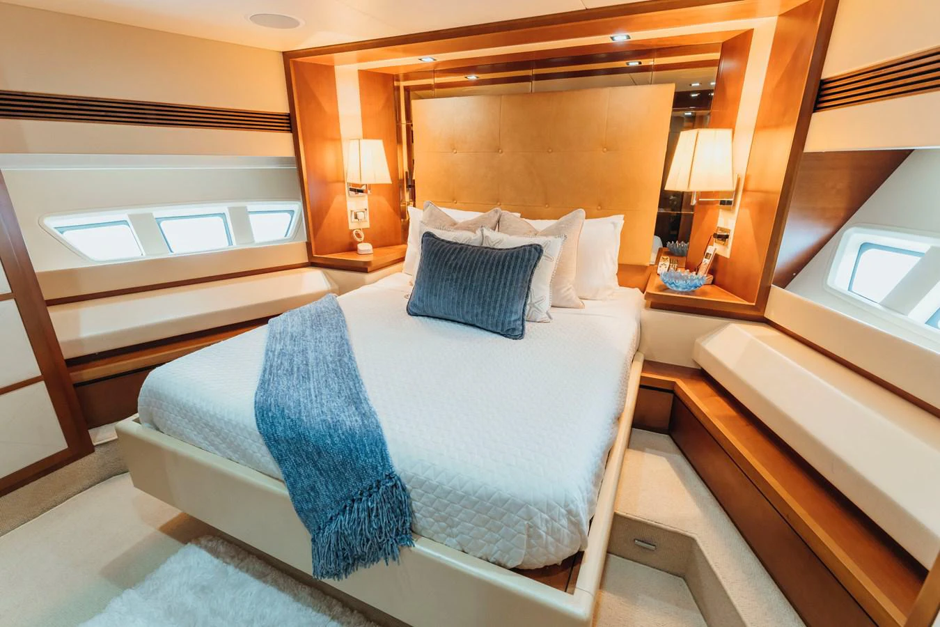 a bed with blue sheets aboard RESET Yacht for Sale