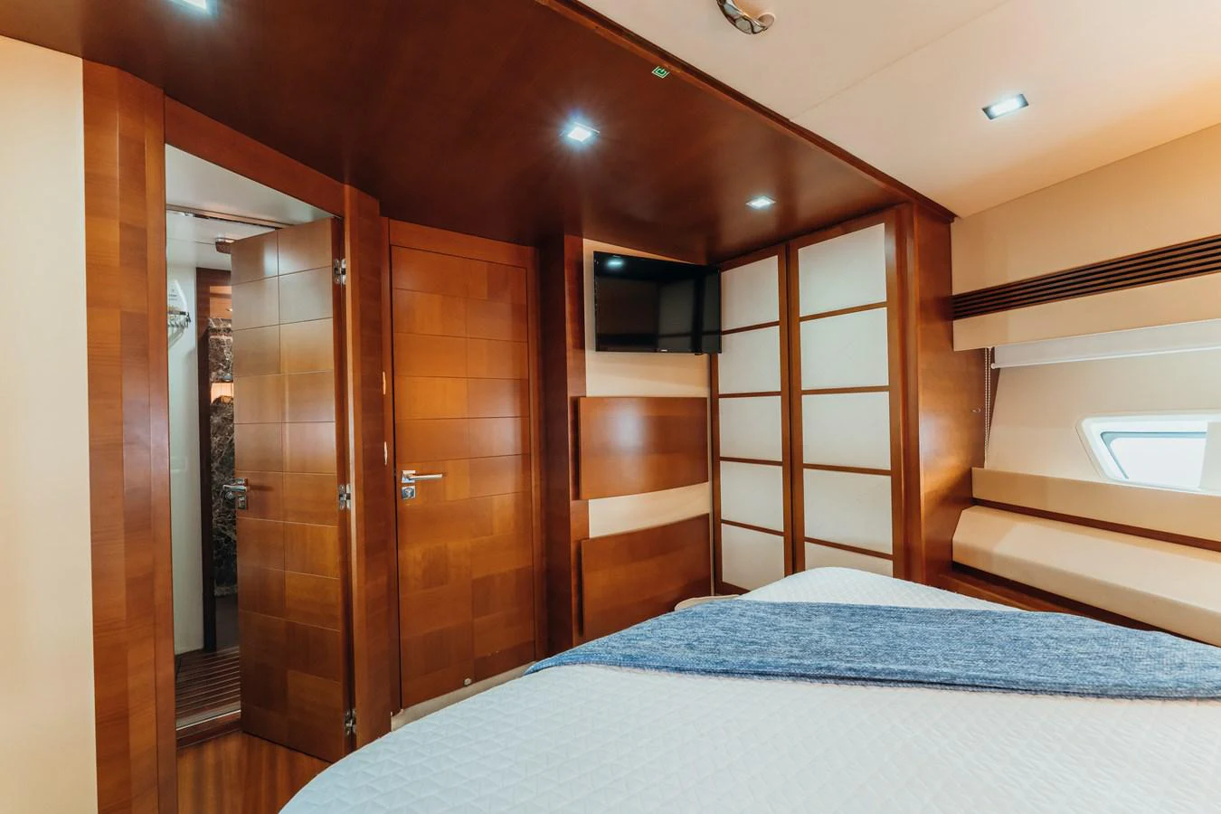 a bedroom with a bed and a closet aboard RESET Yacht for Sale