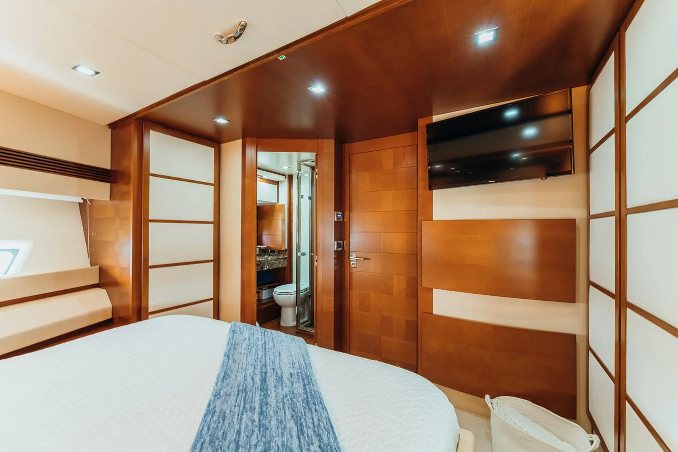 a bedroom with a bed and a closet aboard RESET Yacht for Sale