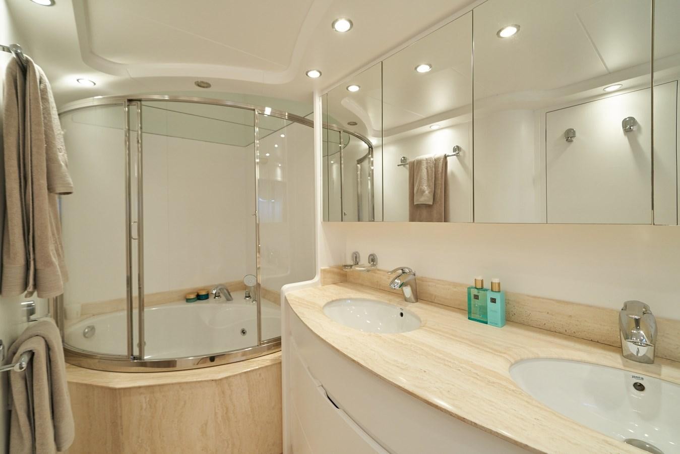 a bathroom with a shower sink and a mirror aboard KIAWAH II Yacht for Charter