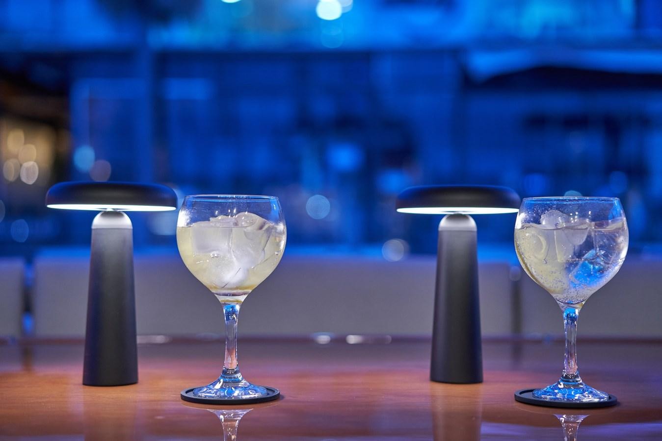 a couple of glasses of wine on a table aboard KIAWAH II Yacht for Charter