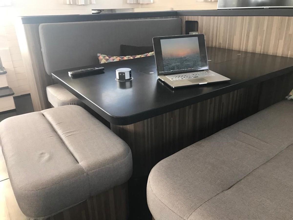 a desk with a laptop and a chair aboard BLACKWOOD I Yacht for Sale