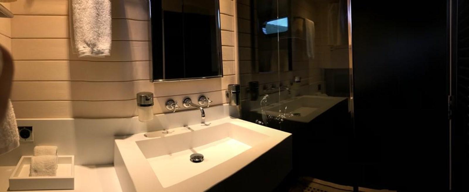 a bathroom with a sink and a mirror aboard BLACKWOOD I Yacht for Sale