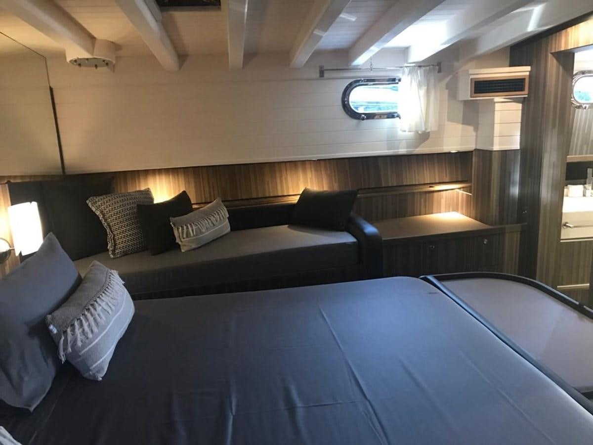 a room with a bed and a window aboard BLACKWOOD I Yacht for Sale