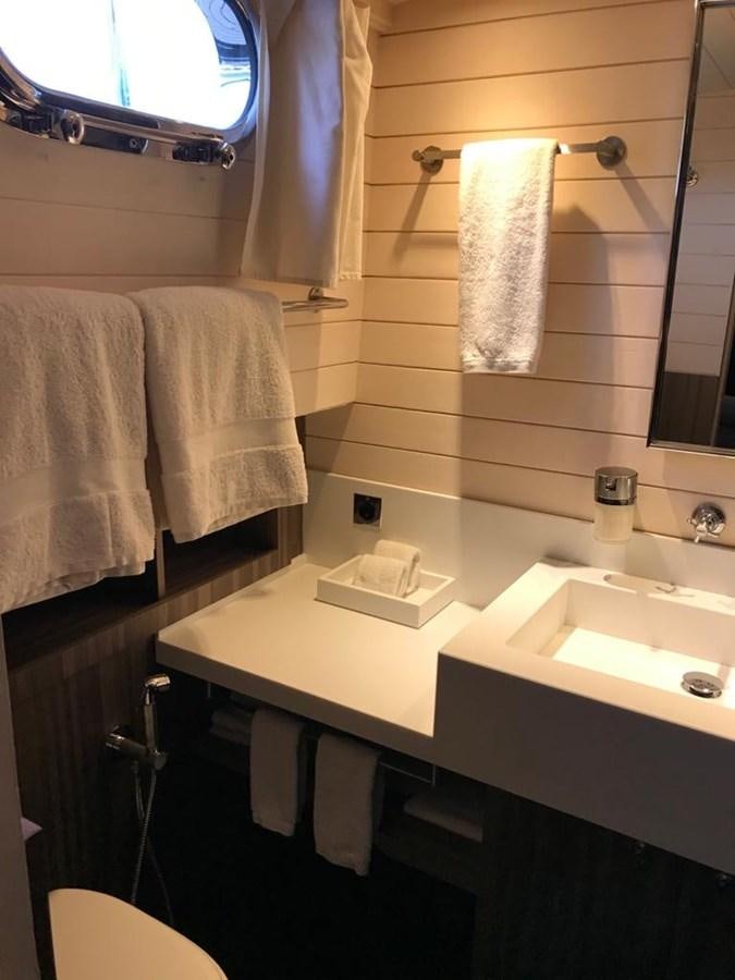 a bathroom with a sink and towels aboard BLACKWOOD I Yacht for Sale