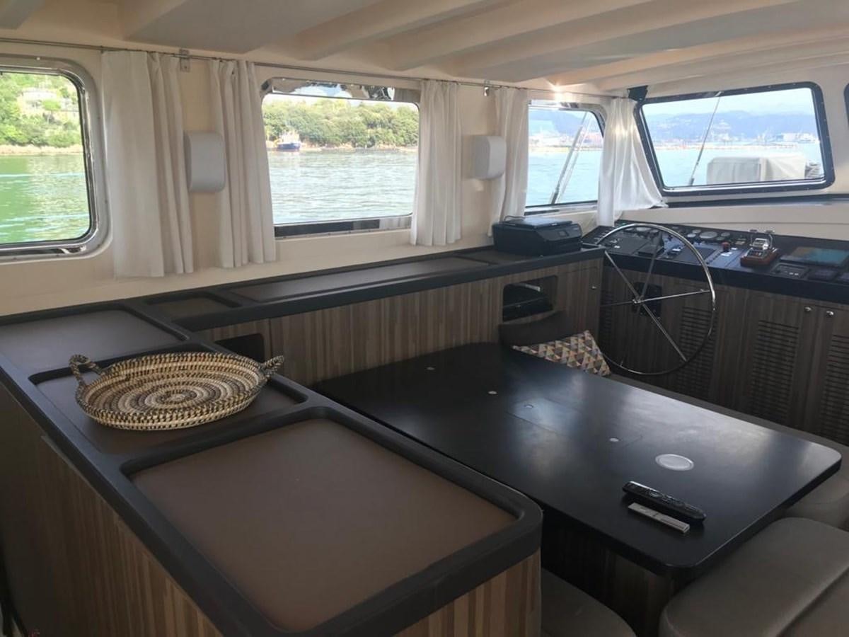 a room with a table and a window aboard BLACKWOOD I Yacht for Sale