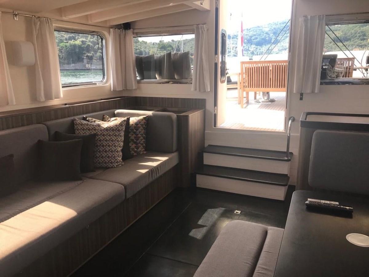 a living room with a couch and a tv aboard BLACKWOOD I Yacht for Sale