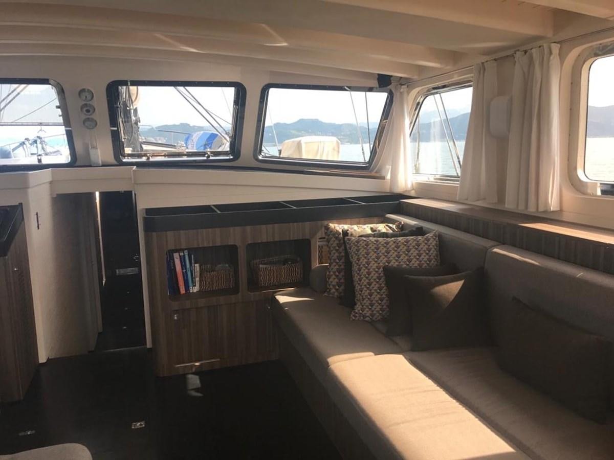 a room with a couch and a window aboard BLACKWOOD I Yacht for Sale