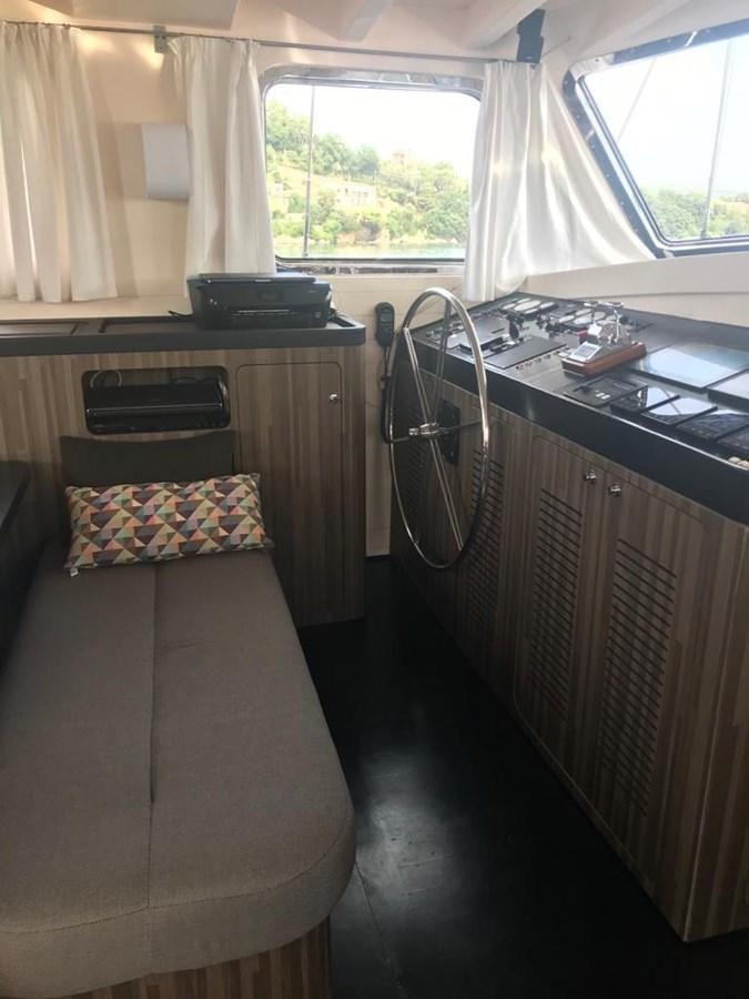 a bedroom with a desk and a bed aboard BLACKWOOD I Yacht for Sale