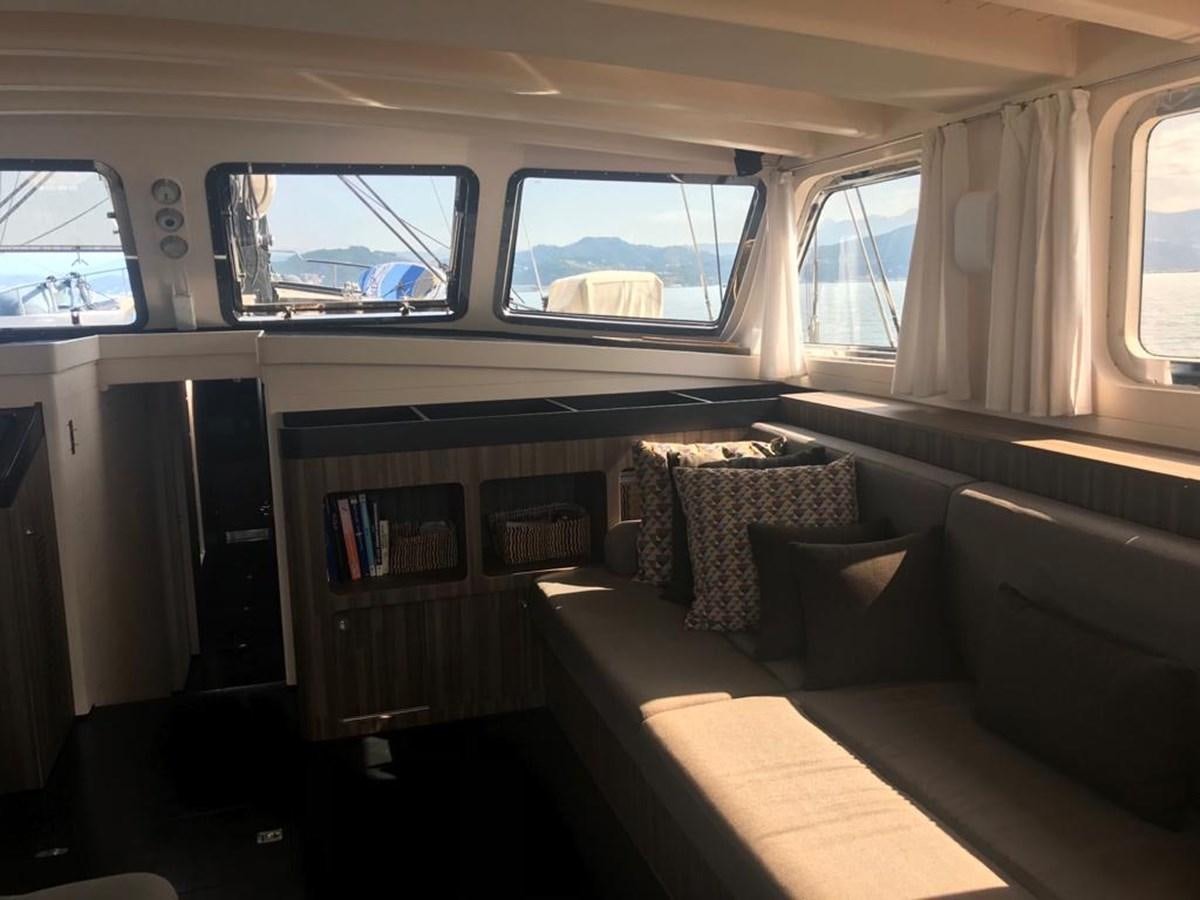 a room with a couch and a window aboard BLACKWOOD I Yacht for Sale