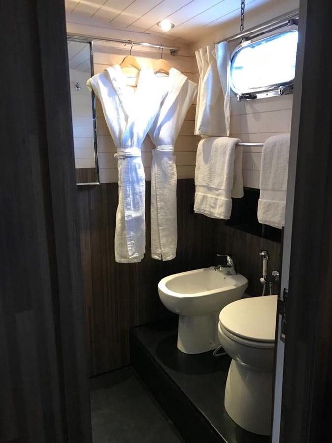 a bathroom with a toilet and a sink aboard BLACKWOOD I Yacht for Sale