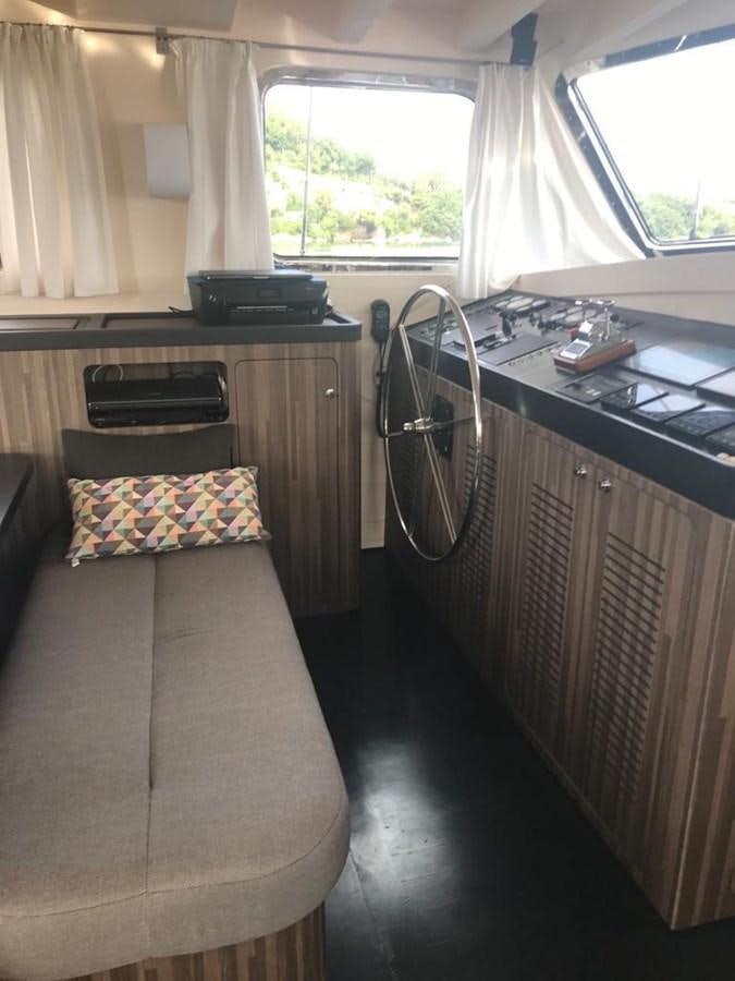 a bedroom with a bed and desk aboard BLACKWOOD I Yacht for Sale
