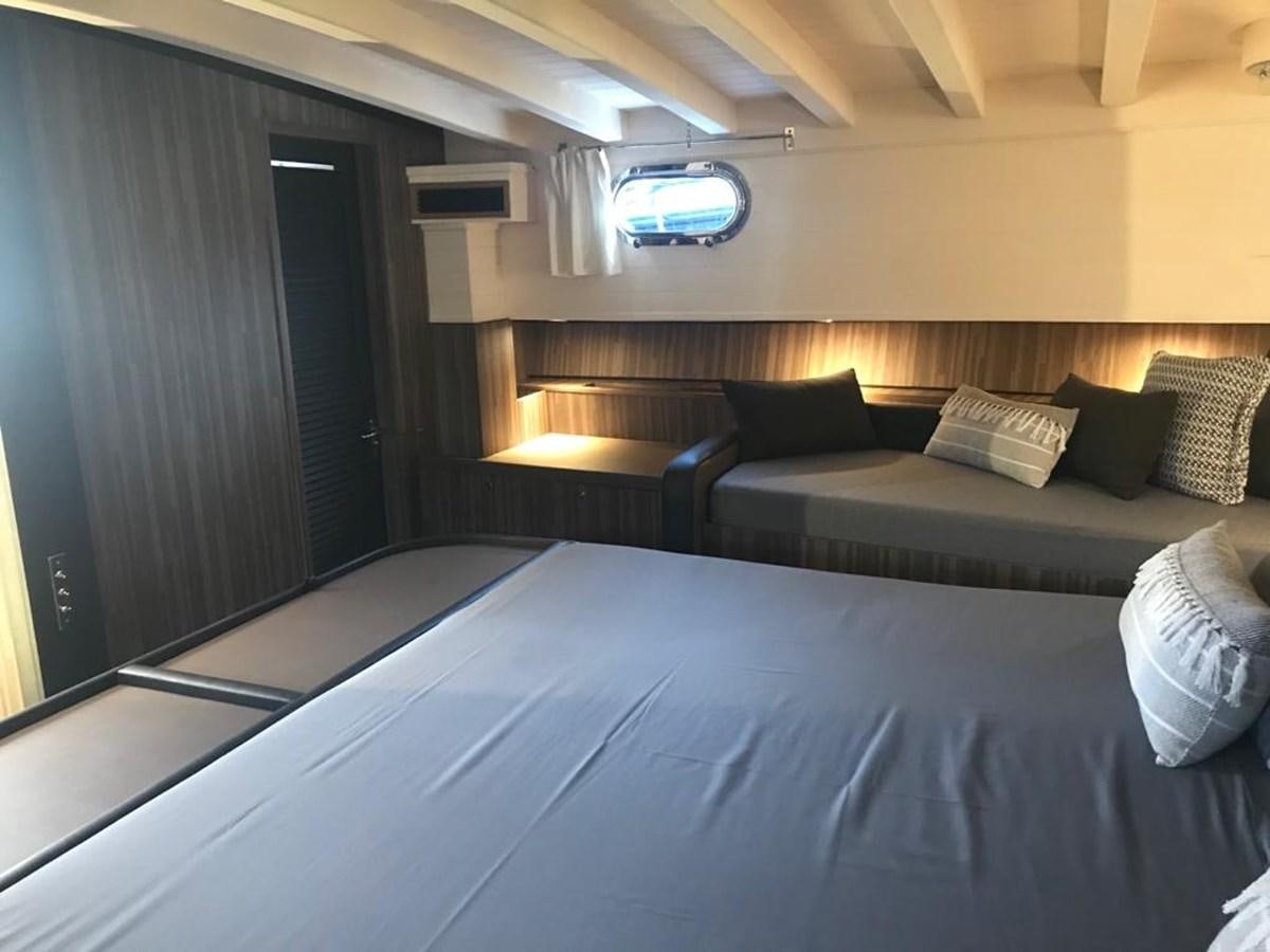 a room with a bed and a window aboard BLACKWOOD I Yacht for Sale