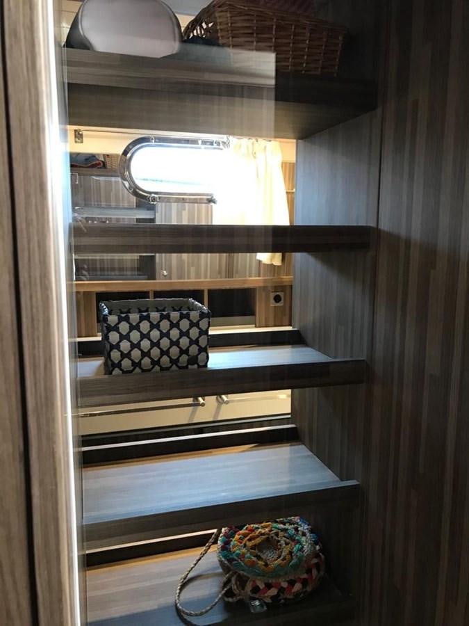 a room with a shelf and a basket with food on it aboard BLACKWOOD I Yacht for Sale