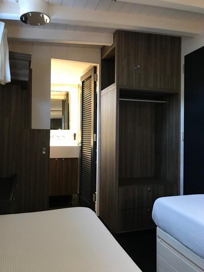 a room with a bed and a closet aboard BLACKWOOD I Yacht for Sale