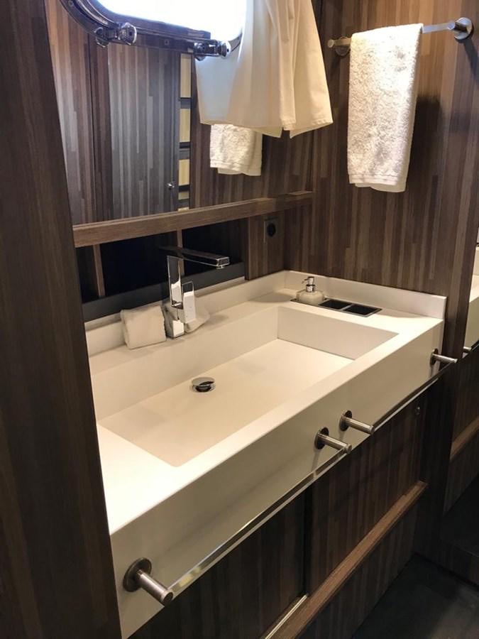 a bathroom with a sink and towels aboard BLACKWOOD I Yacht for Sale