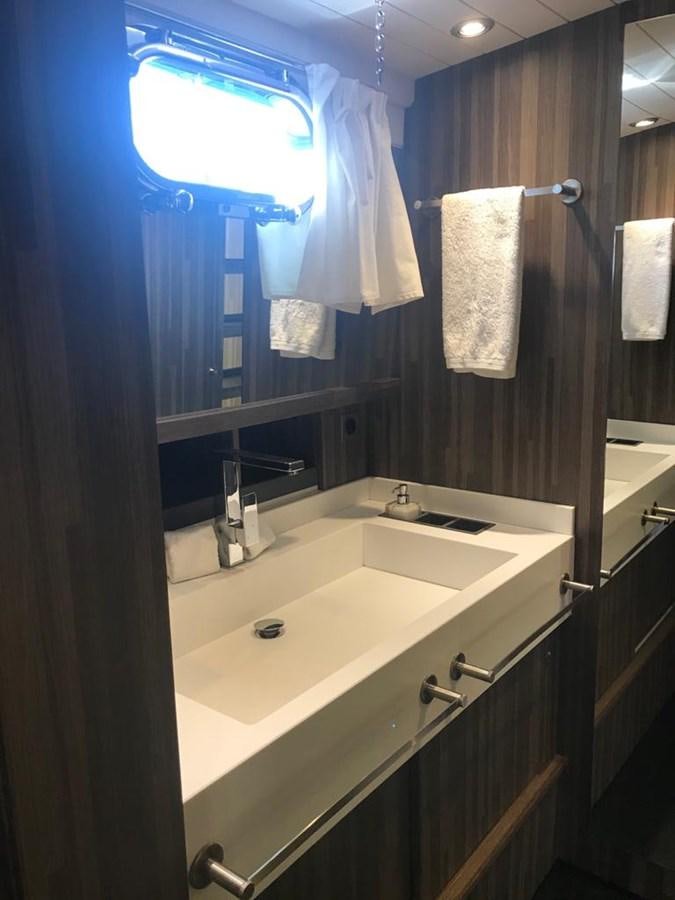 a bathroom with a sink and a mirror aboard BLACKWOOD I Yacht for Sale