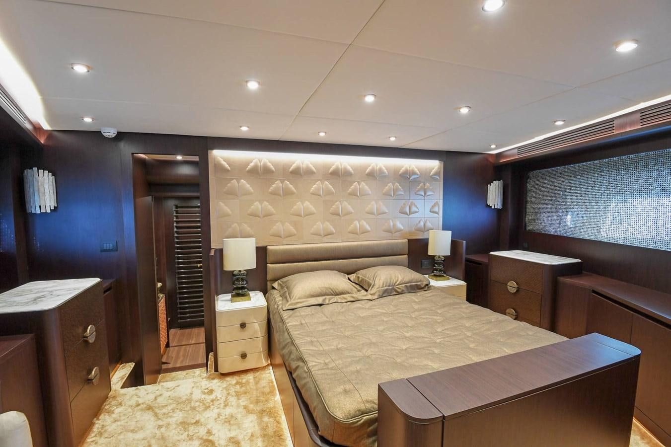 a bedroom with a bed and a dresser aboard CECILOU Yacht for Sale