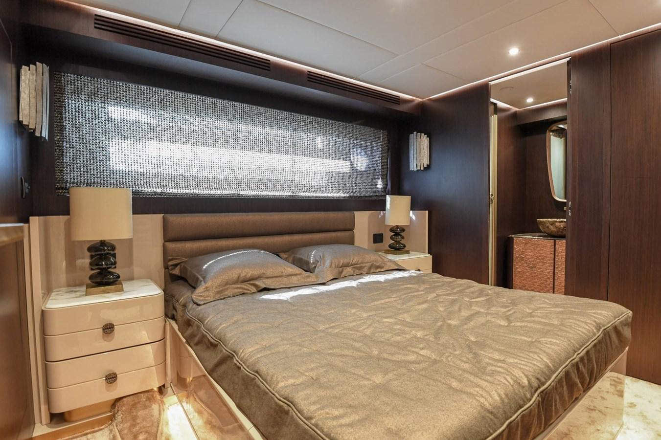 a bedroom with a bed and a lamp aboard CECILOU Yacht for Sale