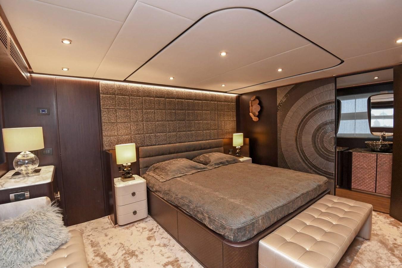 a bedroom with a bed and a lamp aboard CECILOU Yacht for Sale