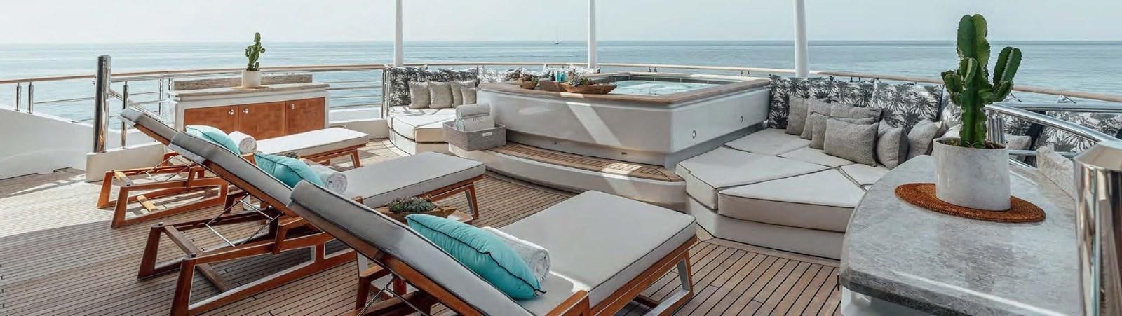 a deck with a large building and a plant on the side aboard SAMSARA Yacht for Charter