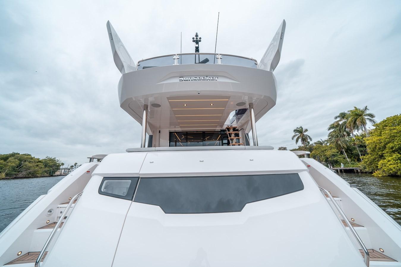 a white boat with a group of people on it aboard MANHATTAN 68 Yacht for Sale