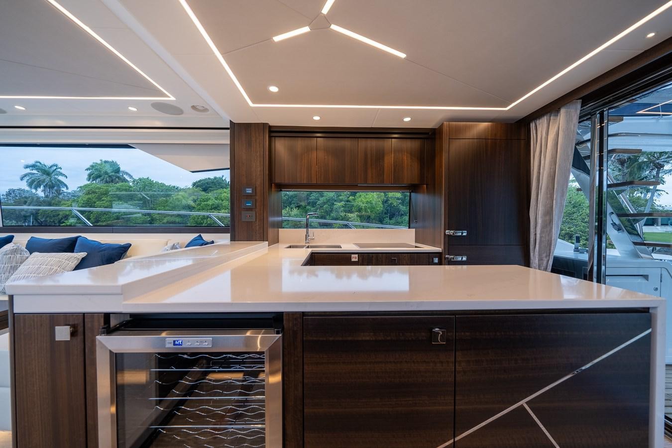 a room with a large window and a desk with a bed aboard MANHATTAN 68 Yacht for Sale