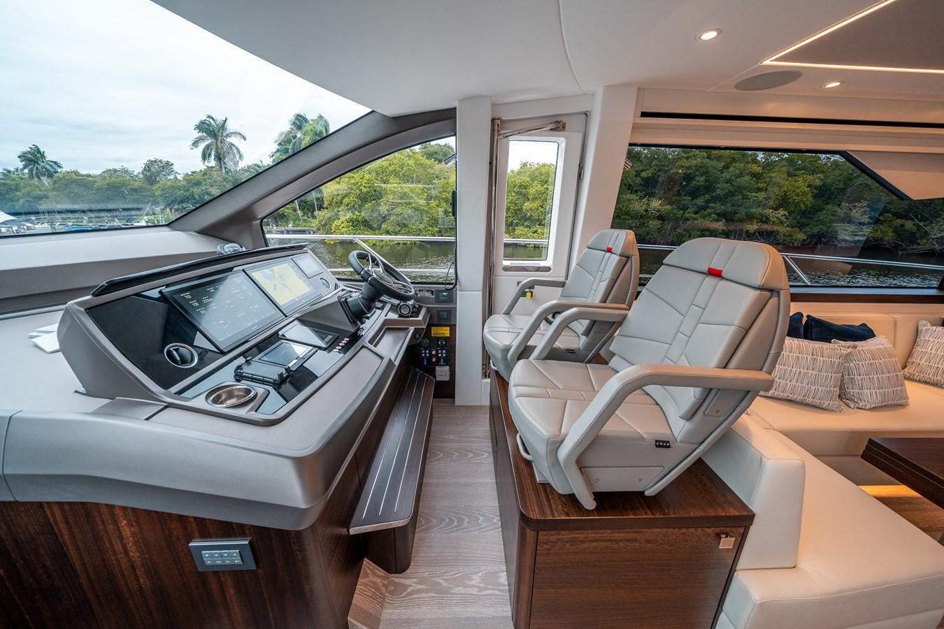 a room with a table and chairs aboard MANHATTAN 68 Yacht for Sale