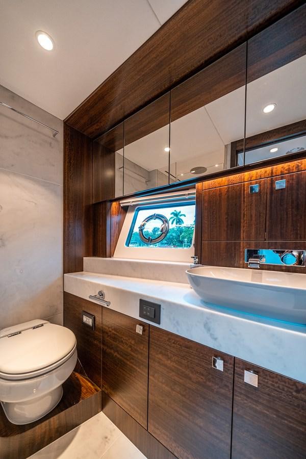 a bathroom with a large mirror aboard MANHATTAN 68 Yacht for Sale