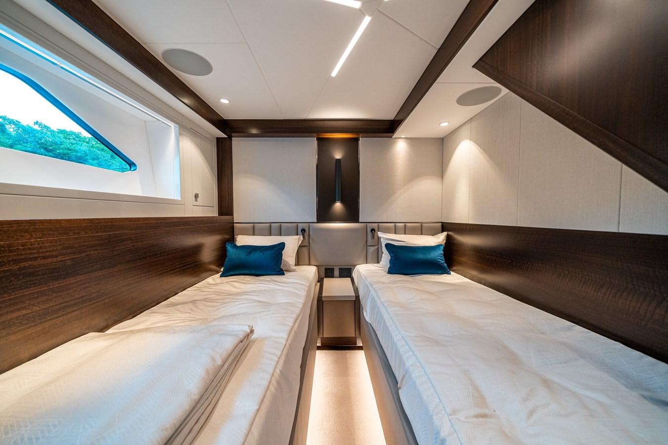 a room with beds and a lamp aboard MANHATTAN 68 Yacht for Sale