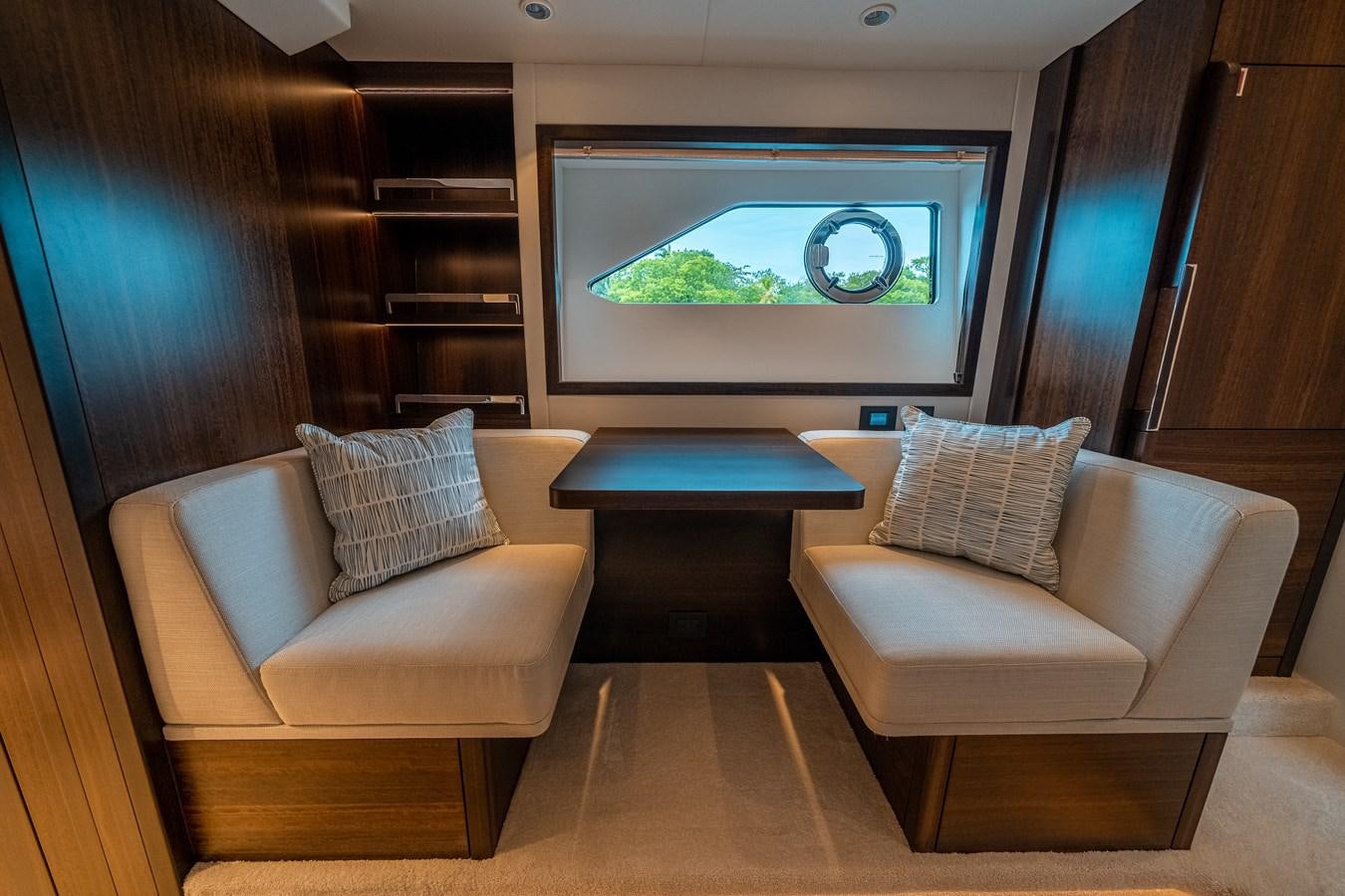 a room with couches and a fish tank aboard MANHATTAN 68 Yacht for Sale