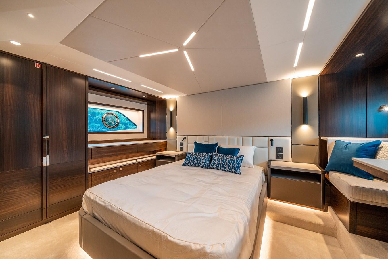 a bedroom with a bed and a desk aboard MANHATTAN 68 Yacht for Sale