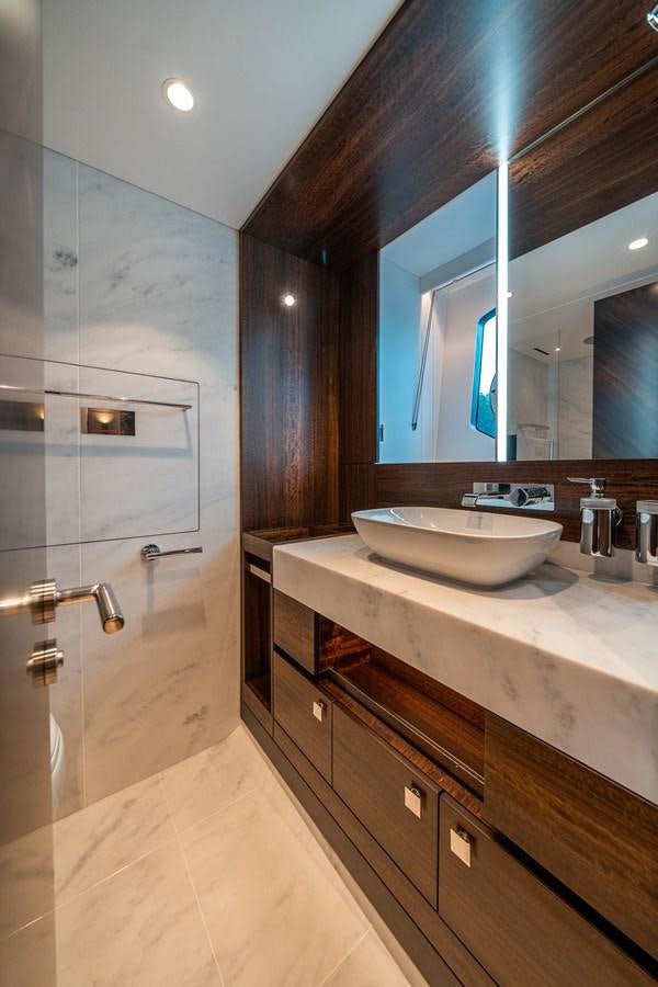 a bathroom with a sink and a mirror aboard MANHATTAN 68 Yacht for Sale