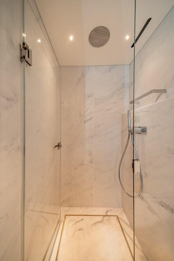 a shower with a tile wall aboard MANHATTAN 68 Yacht for Sale