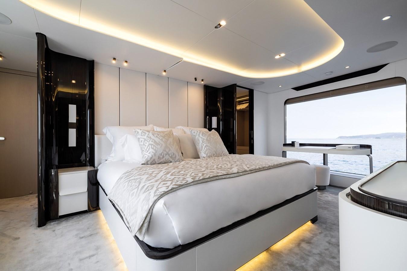 a bed with a white bed spread aboard AZIMUT GRANDE 32M  Yacht for Sale