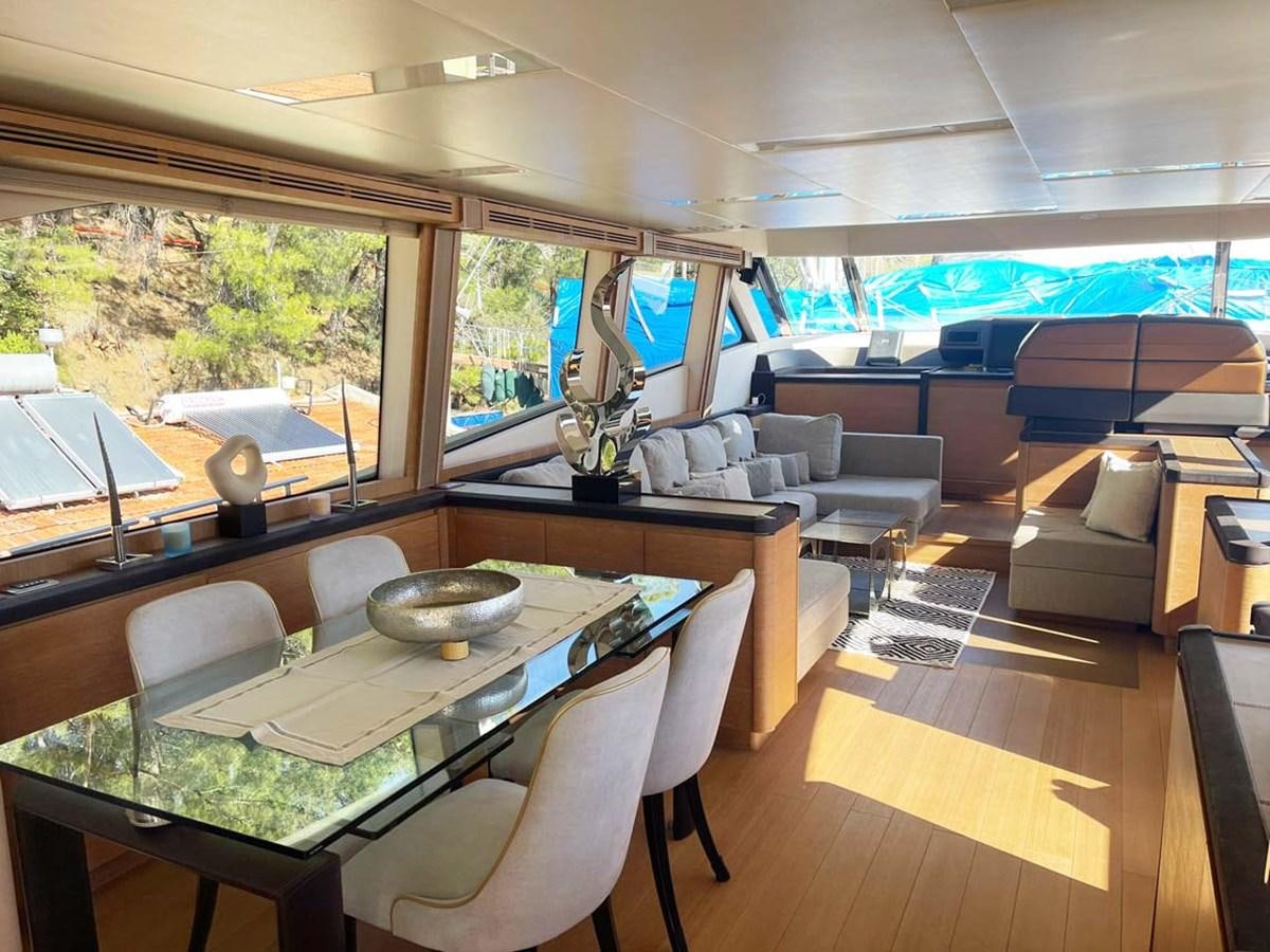 a room with a table and chairs aboard SKYFALL Yacht for Sale
