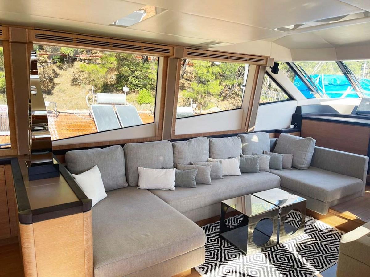 a living room with a couch and a coffee table aboard SKYFALL Yacht for Sale