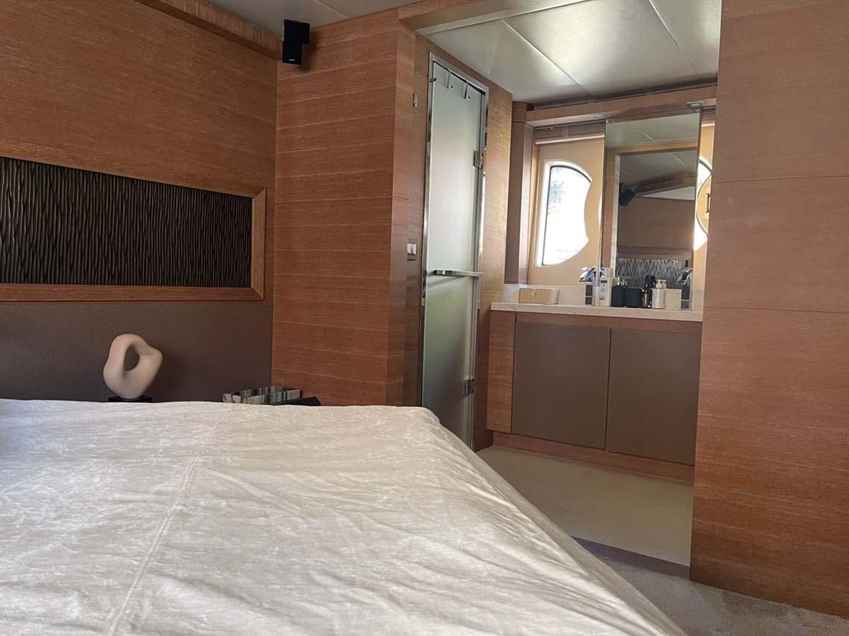 a room with a bed and a mirror aboard SKYFALL Yacht for Sale