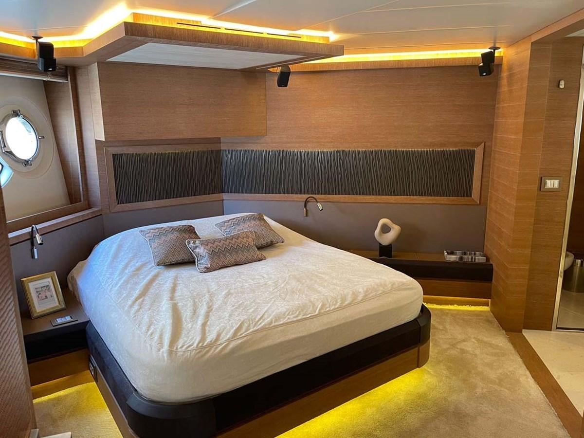 a room with a bed and a mirror aboard SKYFALL Yacht for Sale