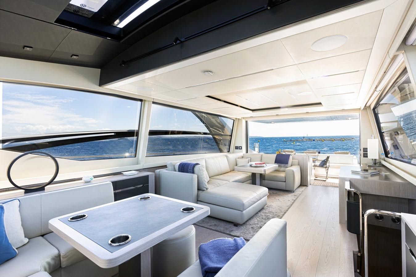 a room with a couch and a table and a large window aboard #15 Yacht for Sale