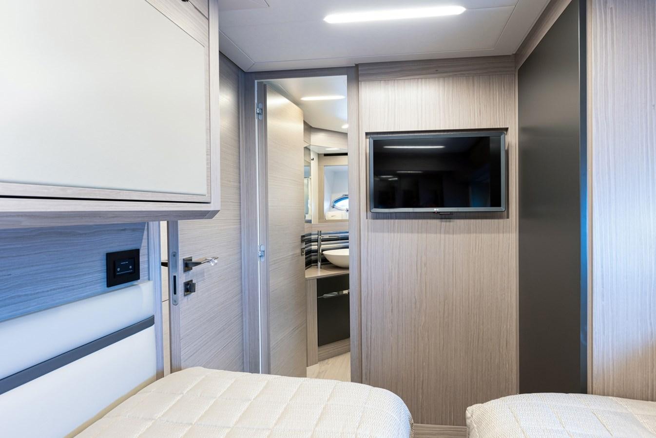 a room with a bed and a television aboard #15 Yacht for Sale