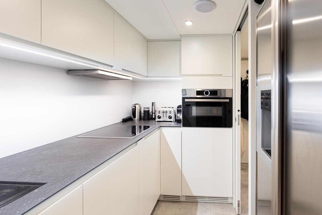 a kitchen with white cabinets aboard #15 Yacht for Sale